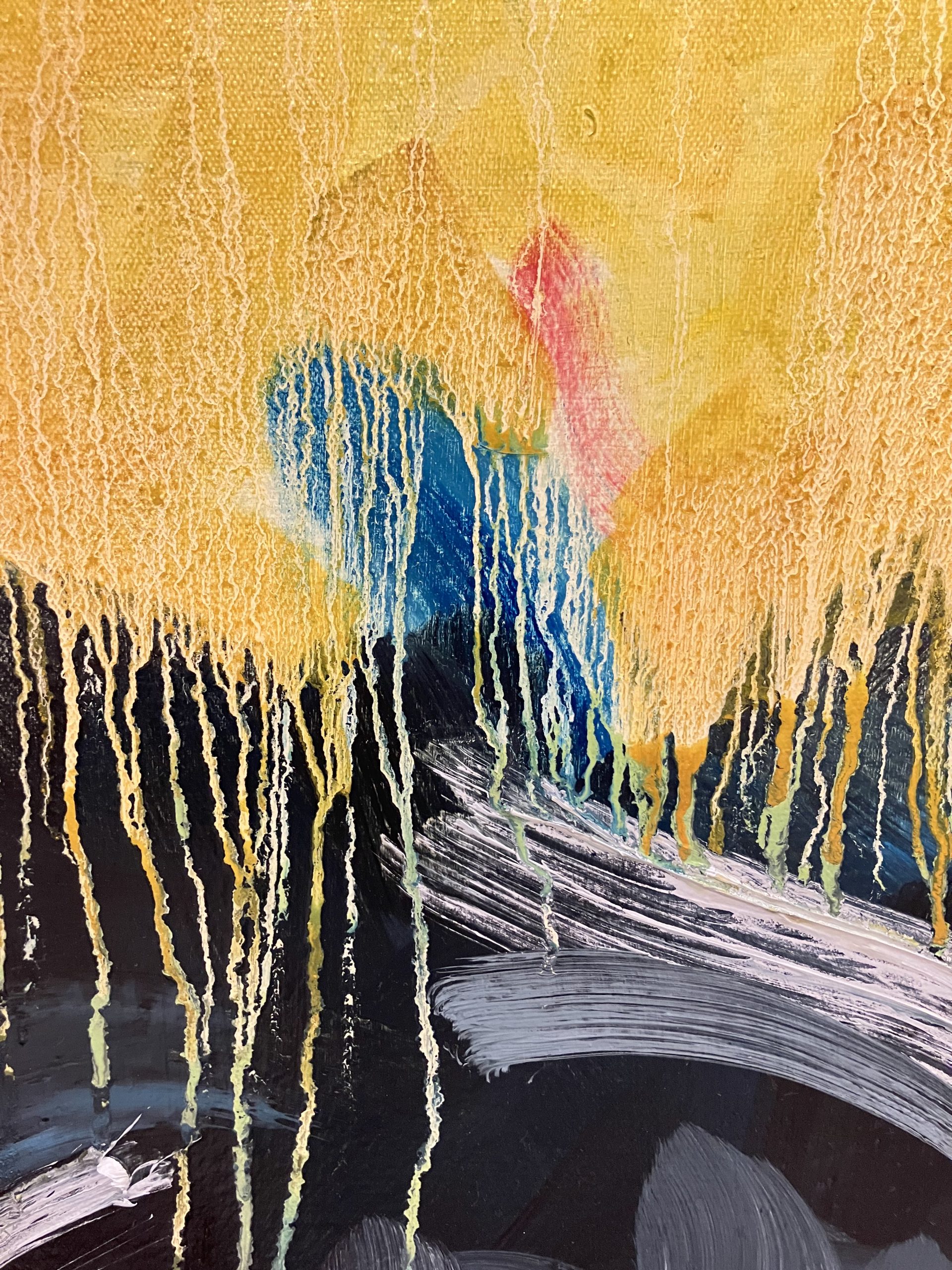 Close-up of the linseed oil drips on the background beside the grey bundle. Primary colors are yellow and black.